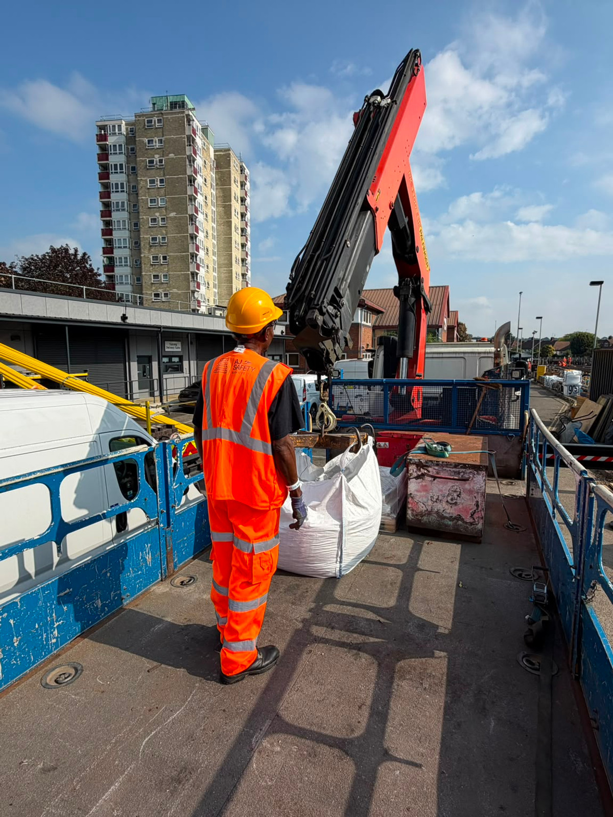 AJ worker beside the hook and lifting equipment of a vehicle-mounted crane