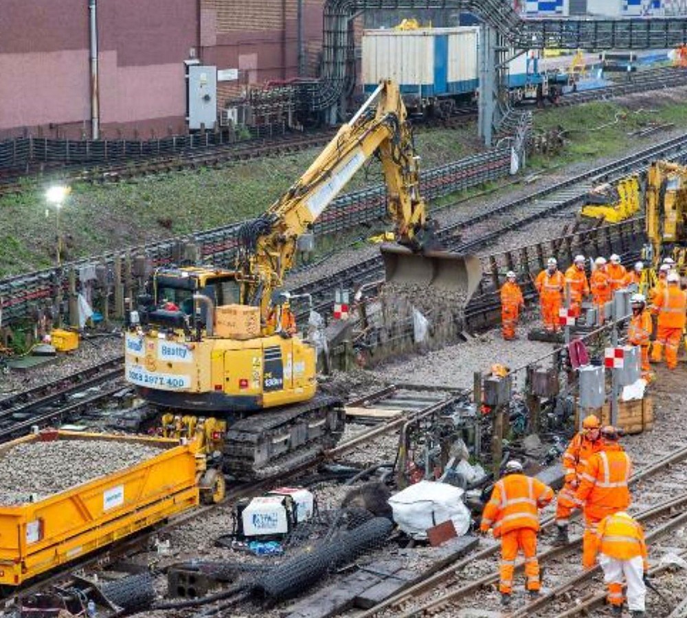 London Underground track renewal worksite with workforce and yellow rail plant