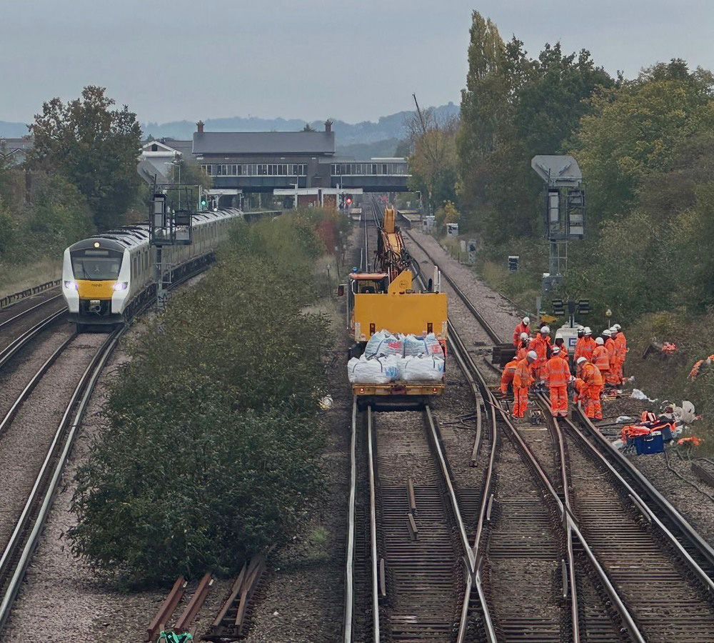 Network Rail mainline project with trains, workforce and rail plant