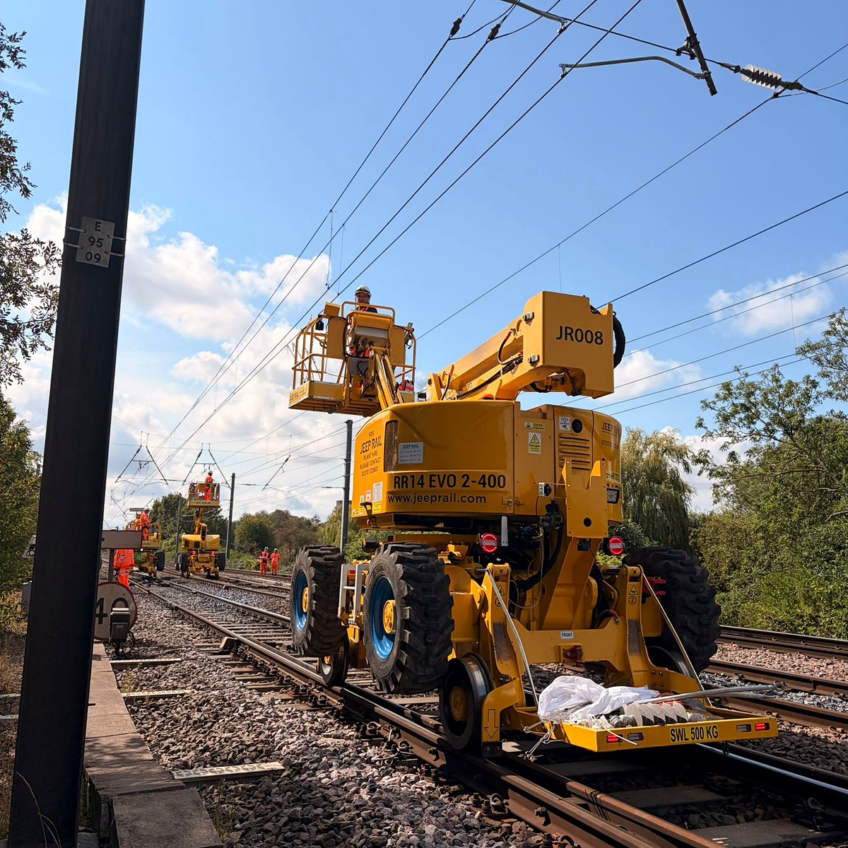 Specialist yellow rail plant supporting overhead line work on the mainline