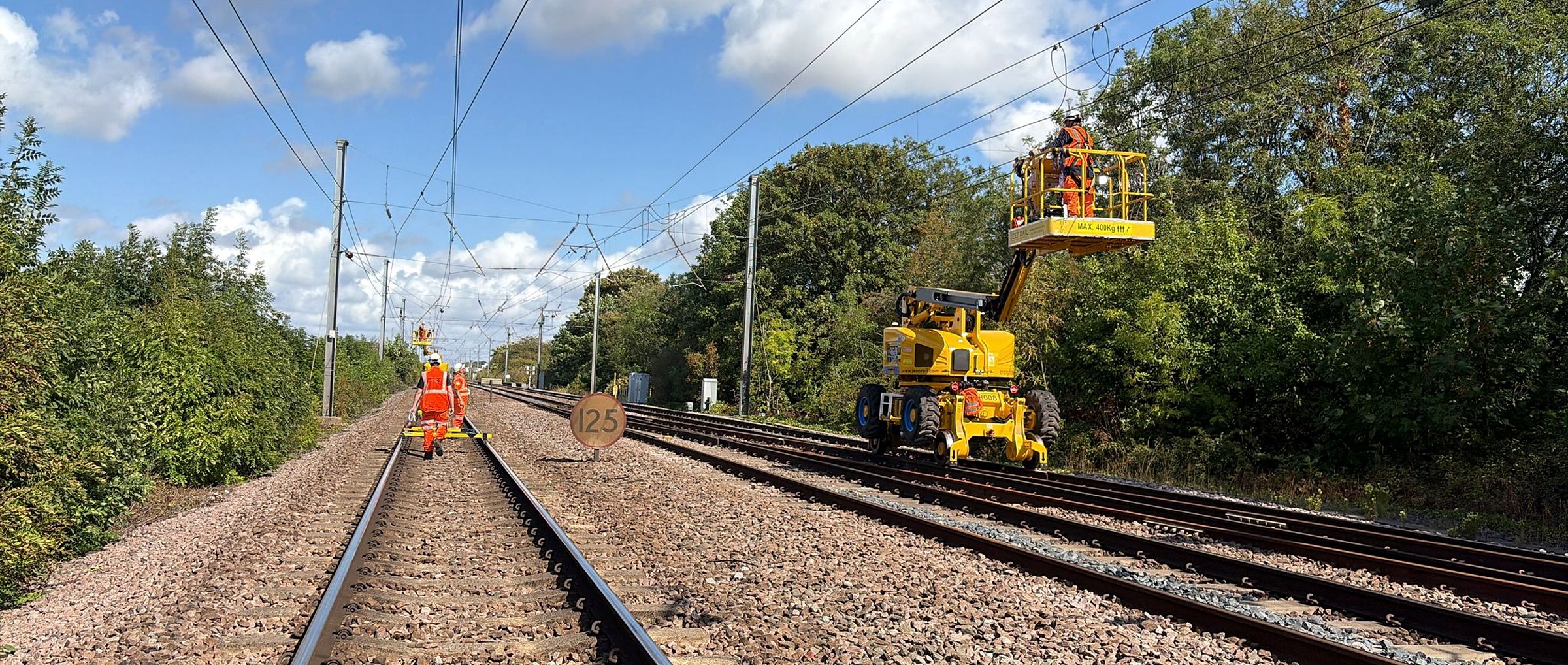 Network Rail overhead line work supported by specialist yellow rail access plant